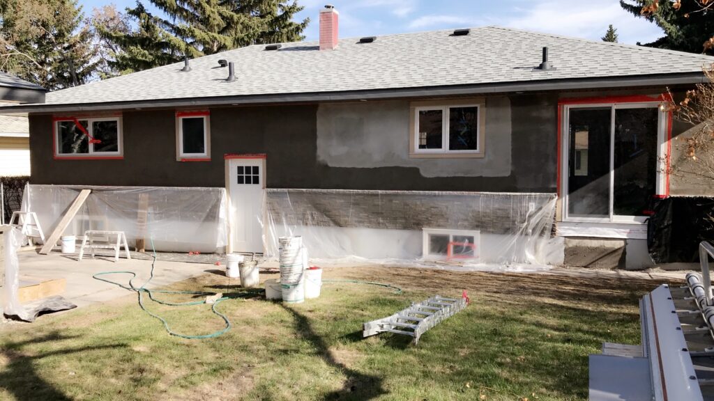 acrylic stucco smooth finish services in progress with all the prep work in Calgary